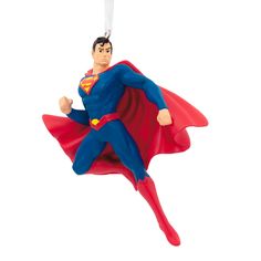 a superman ornament hanging from a string