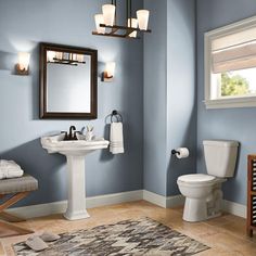 a bathroom with green walls and white fixtures