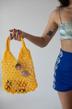 Origin: Handmade in Morocco  Colors: available in a wide range of colors  Description: Inspired by vintage net bags made popular in french markets. The beauty of this bag is its simplicity but also its versatility. It can be used in endless ways! It is definitely your go-to farmer's market bag. Its nautical net vibes make it the perfect beach companion. Or show off (and air out) your cute athletic wear to and from the gym. Vintage Crochet Bag For Everyday Summer Use, Vintage Crochet Bag For Daily Use In Summer, Yellow Crochet Bag For Spring, Vintage Crochet Shoulder Bag For Summer, Spring Yellow Crochet Bag, Summer Retro Shoulder Bag For Shopping, Retro Summer Shoulder Bag For Shopping, Yellow Retro Shoulder Bag For Summer, Spring Market Shoulder Bag