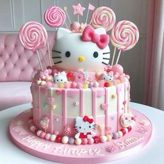 a hello kitty birthday cake with lollipops and candies