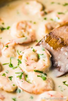 shrimp and clam chowee is in a pot with a wooden spoon, ready to be eaten