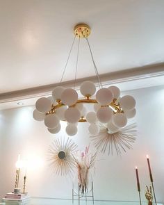 a chandelier hanging from the ceiling in a room with candles and other decorations