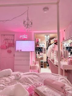 a bedroom with pink walls and lots of stuff on the bed in front of it