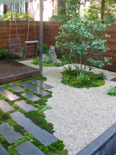 a small garden with rocks and grass