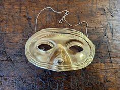 Vintage plastic Halloween gold colored half mask great for wearing and scaring. Overall good condition. Unmarked. Measures 7 inches wide by 4 inches tall. Elastic strap is stapled on but stretched out. PLEASE see photos and video. Great for a party, trick or treating, dress up, or holiday decorating. NOT a medical mask. Previously owned. SOLD AS IS Gold Masks For Halloween Costume Party, Gold Costume Masks For Halloween, Gold Eye Mask For Halloween Masquerade, Gold Eye Mask For Costume Party, Gold Mardi Gras Costume Accessories, Formal Gold Eye Mask, Mardi Gras Costume Accessories In Gold, Gold Masks For Carnival And Formal Events, Gold Costume Accessories For Mardi Gras Carnival