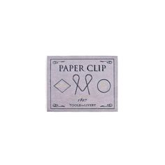 a white paper clip with scissors and other items on it's back side, in front of a white background