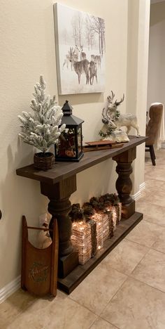 a shelf with christmas decorations on it in a living room next to a wall mounted deer