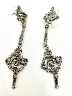 A pair of stunning crystal drop stud dangle earrings , vintage 1970's  styled in a victorian manner  for pierced ears  pre owned good vintage condition , some signs of the silver rubbing on the back thru polishing over the years  split into 3 sections each linked with a jump.  top and bottom both designed with scroll's , with middle being  a slim bar, all 3 sections paved with round white cz crystals  looks amazing on, feel like a film star , pics dont do justice  video on its way  very dazzling , fantastic vintage statement jewellery  in a good used vintage condition size  drop from stud 8.5 cm width at widest 2 cm weight each stud 9 grams Silver Crystal Clip-on Earrings For Formal Events, Silver Dangle Crystal Earrings For Formal Occasions, Victorian Dangle Earrings For Party, Vintage Silver Bridal Earrings For Formal Occasions, Vintage Silver Bridal Earrings For Evening, Silver Vintage Bridal Earrings For Formal Occasions, Victorian Dangle Chandelier Earrings For Parties, Victorian Chandelier Dangle Earrings For Party, Silver Pierced Chandelier Earrings For Evening