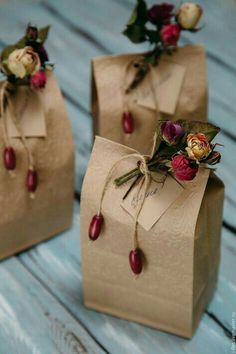 two brown paper bags with flowers on them