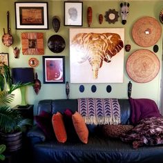 a living room filled with lots of different types of decor on the wall above it