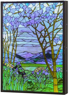 a stained glass window with trees and flowers