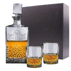 three glasses and a decanter in front of a box with the name william's on it