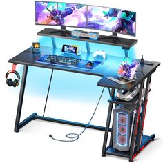 two computer monitors sitting on top of a desk with headphones and gaming accessories next to it