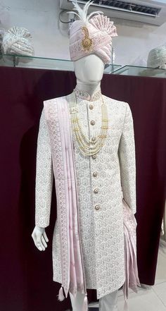 a mannequin dressed in white and pink clothing