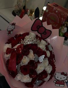 a bouquet of roses with a hello kitty tiara