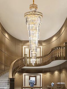 an elegant foyer with chandelier and stairs