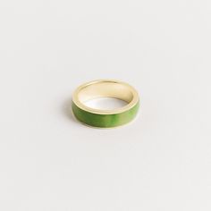 Introducing our 7mm men's inlay band, crafted with the finest green jade. This exquisite ring is a testament to the natural beauty of the stone and the stunning shades of green that jade is known for. We take great pride in sourcing our jade directly from the family that mines it, ensuring that every piece is of the highest quality and ethically sourced. The green jade is expertly cut and polished, then set into the band with precision and care. Our 7mm width is our most popular option, providin Jade Wedding Rings For Men, Formal Green Enamel Ring With Polished Finish, Modern Green Round Band Jewelry, Green Enamel Ring With Polished Finish For Anniversary, Minimalist Green Emerald Ring With Polished Finish, Modern Green Ring For Promise, Modern Green Promise Ring, Green Enamel Ring With Polished Finish As Gift, Modern Green Emerald Ring With Polished Finish