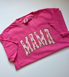 "This Comfort Colors® t-shirt features a charming strawberry print with the word \"mama\" in bold letters. The shirt is made from soft and durable cotton material, ensuring maximum comfort and longevity. It comes in a range of sizes to fit different body types and is perfect for casual wear or as a thoughtful gift for a mother figure in your life. The vibrant colors of the print are sure to make a statement and add a touch of sweetness to any outfit. All items are made to order in the order in w Shirts For Moms, Fruit Shirt, Mama Shirts, Strawberry Print, Mama Shirt, Graphic Tees Women, Tshirt Colors, Branded T Shirts, Strawberries