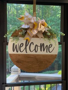 a welcome sign hanging from the side of a window