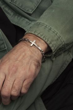 "I designed this sleek and modern cross bracelet with the cross slightly concave, to  comfortably conform and hug the wrist.  Handcrafted from 925 sterling silver, it  features my classic technique of brushing the silver and then adding a black oxide  finish to add depth and reflection. A high-end jewelry piece ideal for a  conformation gift or other religious occasion, the round link chain is also made of  925 sterling silver.  DETAILS ⚬ Handmade in 925 sterling silver.  ⚬ Cross is 4cm long x 3 Christian Jewelry For Men, Cross Bracelet For Men, Christian Jewellery, Aviation Jewelry, Silver Cross Bracelet, Jewellery Gifts, Bracelet Chain, Christian Jewelry, Bracelet For Men