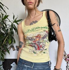 🖇Condition: 5-/5 📌Brand: Ed Hardy 🔖Tag size: M Bust 12.2 in 31 cm Length 20.08 in 51 cm Waist 10.24 in 26 cm Y2k Fitted Sleeveless T-shirt, Vintage Sleeveless T-shirt With Graphic Print, Casual Graphic Print Tank Top, Graphic Print Racerback Top For Streetwear, Y2k Tops With Sublimation Print For Spring, Casual Racerback Tops With Letter Print, Casual Racerback Tank Top With Letter Print, Y2k Sleeveless Printed Tops, Ed Hardy Tank Top