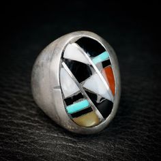 Wonderful Vintage Zuni Ring by Ralph and Lillie Kallestewa, they have been active jewelers since the 1950s.This ring is a  Multi Stone Sterling Silver Inlay, with Turquoise, Jet, Mother of Pearl and Coral.  This ring will look great on both men and women. Size 10 1/2 Measures 1 " tall Weight 18.9 grams Collectible Multi-stone Turquoise Oval Ring, Vintage Collectible Opal Gemstone Ring, Vintage Opal Ring Collectible, Artisan Rings With Inlay For Anniversary, Art Deco Multi-stone Collectible Jewelry, Oval Multi-stone Gemstones For Collectors, Southwestern Multi-stone Jewelry For Anniversary, Modernist Multi-stone Ring, Unique Multicolor Rings With Polished Finish