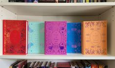 several books are lined up on a book shelf in front of some bookshelves