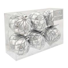 four silver christmas ornaments in a clear box on a white background, with the packaging