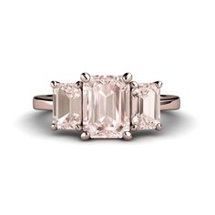 three stone engagement ring in rose gold with an assorted pink diamond on the side