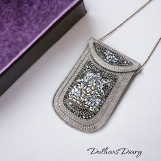 Introducing our Metal Mobile Shape Mini Handbag, a stylish fusion of elegance and functionality. Adorned with intricate mosaic work and gracefully curved around the bag, this accessory exudes a unique vintage charm. The beautiful silver chain adds a touch of sophistication, making it not just a handbag but a statement piece. Designed for modern living, this mini handbag is perfect for carrying essentials with style. Its compact size ensures convenience on the go, while the exquisite craftsmanshi Luxury Portable Rectangular Pouch, Silver Rectangular Evening Bag, Fashion Clutch Pouch For Mobile Phone, Elegant Clutch Phone Bag As Gift, Elegant Square Portable Phone Bag, Elegant Square Phone Bag As Gift, Elegant Shoulder Phone Bag As Gift, Silver Mobile Phone Bag As Gift, Evening Rectangular Mobile Phone Pouch