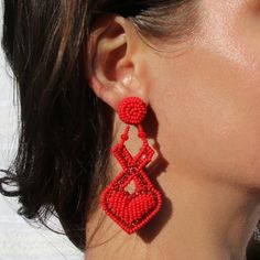 "Red XOXO heart earrings perfect for Valentine's day date outfits and gifts for a girlfriend or daughter that loves statement fashion pieces. Hand beaded lightweight earrings crafted by the female artisans from the indigenous Embera tribe of Columbia. Materials: Red glass Beads, metal set crystals, Surgical steel posts Measurements: Width: 2\" Length: 2.25\" Weight: 0.6 oz Hyperallergenic Post back Closure About the brand partner: Treasure Jewels is a small family owned, fair trade jewelry brand based in Colombia. Each piece is crafted by a local group of female Colombian artisans and jewelers, many of whom are single mothers seeking to support their families. By supporting these talented artisans with more than living wages, we create significant economic impact for this community of arti Red Heart Beads Earrings For Party, Red Dangle Earrings With Heart Beads, Red Heart Beads Jewelry For Summer, Red Heart Bead Drop Earrings, Red Heart Beads Drop Earrings, Red Handmade Heart Earrings For Party, Red Beaded Earrings For Valentine's Day, Elegant Red Heart Beads Earrings, Valentine's Day Beaded Earrings For Pierced Ears