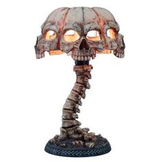 a skeleton lamp with two glowing eyes on it's head and arms, in the shape of a human skull