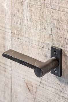 a metal handle on a wooden door