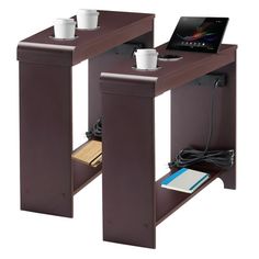 two computer desks with one laptop on top and the other holding coffee mugs