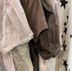 an assortment of clothing hanging on a clothesline with stars and laces around them