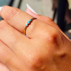 a close up of a person's hand with a ring on it