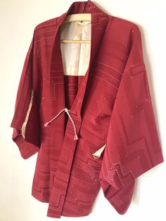 A woman's Haori Kimono jacket in Burgundy Wine hue.  This versatile vintage Japanese cardigan transitions seamlessly from office to evening, paired with jeans or dressed up. The perfect piece for your capsule wardrobe. Fits a USA woman size M. International Express Shipping includedsee below) MATERIAL:  Textured Silk crepe.  Synthetic lining. PATTERN: Geometric lines & dots. COLOR: Burgundy wine & white. CONDITION:  Used, vintage.  Good condition with some interior stains (see photo). Kimono are