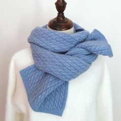 a white sweater with a blue scarf on it