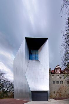 an unusual building with a garage in front of it