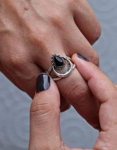 Embrace celestial elegance with our Crescent Moon Black Onyx Ring. Handcrafted from 925 sterling silver, it features a teardrop black onyx stone, reminiscent of the night sky. This half-moon statement piece is perfect for adding a touch of celestial charm to your jewelry collection. Gemstone Details: Name : Black Onyx Gemstone Shape : Teardrop Stone Size : 7*10 mm Metal : Sterling Silver 925 Stamped ✅ Our USP- ✔ Team of Best and Specialized Artisans ✔ Natural and Quality Gemstones ✔ No Nickle and No Cadmium ✔ Wholesaler and Exporter ✔ Production capacity of 10,000+ pcs per month Delivery Time- ✔ Production time differs depending on the product style as every item is handmade with love. Feel free to contact us for any queries or customization. Moon Phase Open Ring, Moon Phase Open Ring For Promise, Black Sterling Silver Moon Phase Jewelry, Black Sterling Silver Jewelry With Moon Phase, Silver Crescent Gemstone Ring, Crescent Silver Gemstone Ring, Crescent Silver Ring With Gemstone, Bohemian Open Ring With Moon Phase, Black Sterling Silver Celestial Jewelry