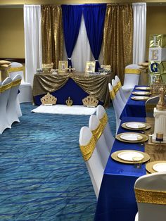 a banquet room set up with blue and gold linens