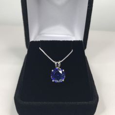 "Beautiful Brilliant Tanzanite* & Sterling Silver Pendant Necklace * 1.7ct Brilliant Cut Tanzanite* measures 8mm Round * Solid Sterling Silver * 16\" - 24\" Sterling Silver Chain included (select your length) Hallmarked & Gift Ready! *Tanzanite is one of very few gemstones that cannot be grown in a Lab, however, these Laboratory Grown Simulate Stones are optically identical to a natural Tanzanite in color and are just as hard but, do not have the same Chemistry or Composition as Tanzanit Classic Tanzanite Necklace With Brilliant Cut, White Gold Necklace With Diamond Cut Lab-created Sapphire, Round Diamond Cut Lab-created Sapphire Necklace, Sapphire Necklace With Prong Setting, Diamond Cut Lab-created Sapphire Necklace, Round Diamond Cut Necklace With Lab-created Sapphire, Round Lab-created Sapphire Necklace With Diamond Cut, Lab-created Sapphire Diamond Cut Necklace, Sapphire Jewelry With Brilliant Cut Round Stone