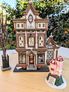 a wooden table topped with a toy house