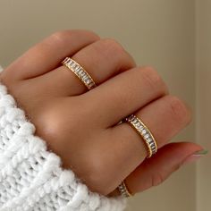 Baguette Eternity Ring features baguette crystals that perfectly hugs around the entire band. So whether you're looking at it from the top, down, left or right, it's going to sparkle back at you. Designed with a border, this band is very comfortable to wear. MATERIALS: Gold Plated, Brass Cubic Zirconia  Need some jewelry inspiration? Follow us on Instagram @statementGrey Cubic Zirconia Eternity Band With Baguette Diamonds As Gift, Cubic Zirconia Baguette Rings For Gifts, Baguette Cut Cubic Zirconia Stackable Rings As Gift, Baguette Rings For Gift, Gift Baguette Diamonds Stackable Rings, Gift Stackable Baguette Diamond Rings, Cubic Zirconia Crystal Ring With Baguette Cut, Baguette Cut Cubic Zirconia Crystal Ring As Gift, Cubic Zirconia Crystal Ring Baguette Cut Gift