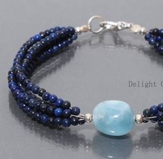 PRODUCT DETAIL : ITEM : LAPIS LAZULI BEADED BRACELET ITEM CODE : DGC2863 ITEM NAME :BRACELET GEMSTONE : LAPIS LAZULI/ MILKY AQUAMARINE BEADS SHAPE : SMOOTH ROUND/ TUMBLE LENGTH : 8 INCH BEADS SIZE: 3mm/12x14mm APPROX WEIGHT : 75 Cts. APPROX CUSTOMIZATION/BULK ORDER : AVAILABLE PLEASE FEEL FREE TO CONTACT IF YOU REQUIRE ANY FURTHER INFORMATION. Blue Oval Beads Bracelets As Gift, Adjustable Lapis Lazuli Beaded Bracelet With Faceted Beads, Blue Lapis Lazuli Bracelets With Polished Beads, Adjustable Blue Lapis Lazuli Beaded Bracelets, Luxury Lapis Lazuli Gemstone Beaded Bracelets, Hand-strung Lapis Lazuli Beaded Bracelets, Halloween Beaded Jewelry, Aquamarine Bracelet, Tigers Eye Necklace