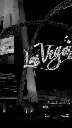 the las vegas sign is lit up in black and white for night time viewings