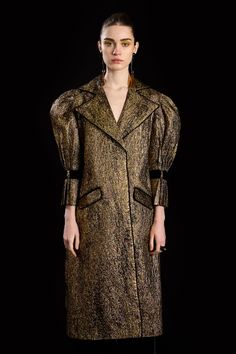 Antique gold trench coat with woven jacquard, faux pockets and velvet band on sleeves. Comes with a waist belt. - Aza Fashions Luxury Gold Outerwear For Evening, Elegant Gold Winter Outerwear, Luxury Gold Party Outerwear, Gold Formal Winter Outerwear, Designer Gold Formal Outerwear, Fall Party Outerwear With Belted Cuffs, Luxury Outerwear With Padded Collar For Formal Occasions, Designer Fitted Gold Outerwear, Gold Fitted Designer Outerwear