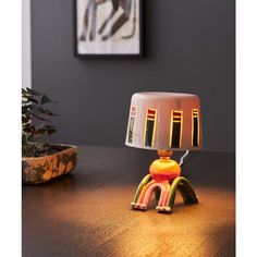 a lamp sitting on top of a wooden table