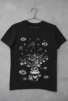 Thanks for stopping by! Eyeballs T-shirt Printed on a super soft, cotton tee Dispatched in 5 working days or sooner Unisex Free UK delivery Material: 100% ringspun cotton. Chest (to fit): S  34/36   M  38   L  40/42   XL  44/46   XXL  48/50 ECO-FRIENDLY Each garment is made to order, reducing extra material and energy that would be otherwise wasted We use DTG printing process which is easier on the environment than screen-printing Our ink is bright and also eco-friendly. Do not tumble dry. Wash Black Goblincore Top With Graphic Print, Black Fairy Grunge T-shirt For Streetwear, Black Fairy Grunge Tops For Halloween, Fairy Grunge Black Halloween Top, Fairy Grunge Halloween T-shirt With Crew Neck, Halloween Fairy Grunge T-shirt With Crew Neck, Black Goblincore Tops For Halloween, Black Fairy Grunge Cotton T-shirt, Halloween Fairy Grunge Tops