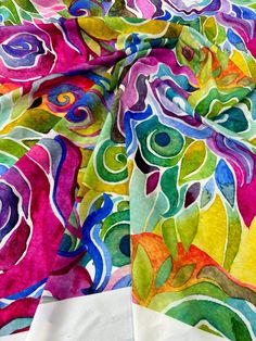 an image of colorful fabric with flowers on it